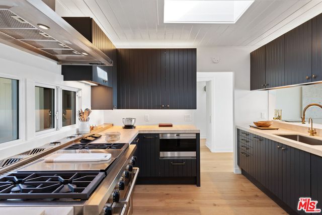 a kitchen with a stove and a sink