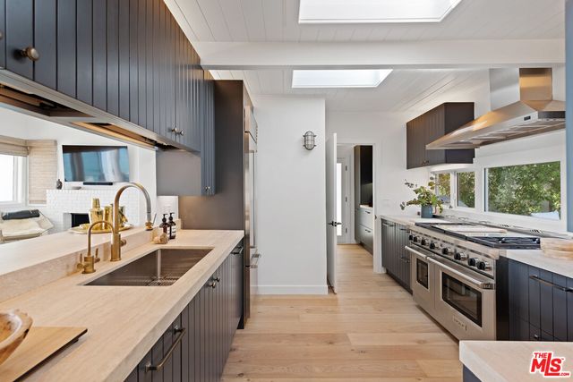 a kitchen with a stove a sink and a refrigerator