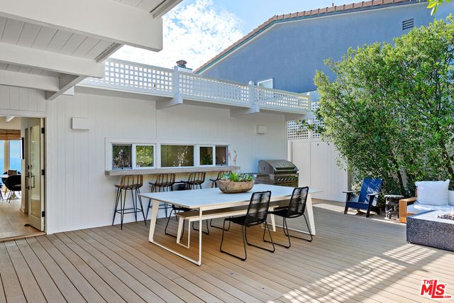 a view of a living room with furniture and mirror