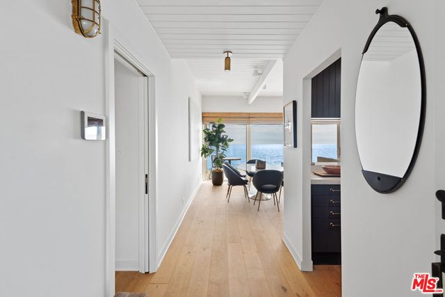 a living room with furniture a fireplace and a potted plant