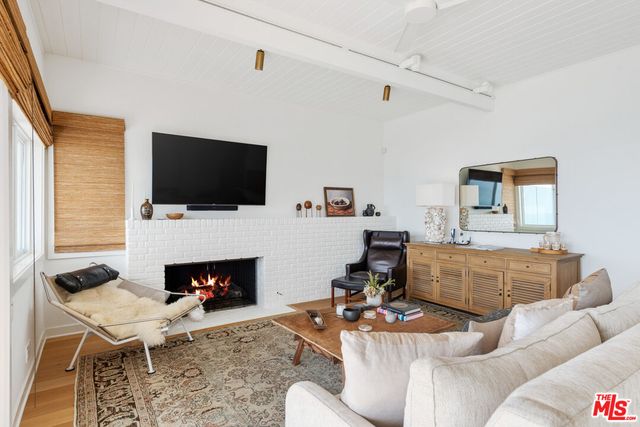 a living room with kitchen island furniture and a potted plant