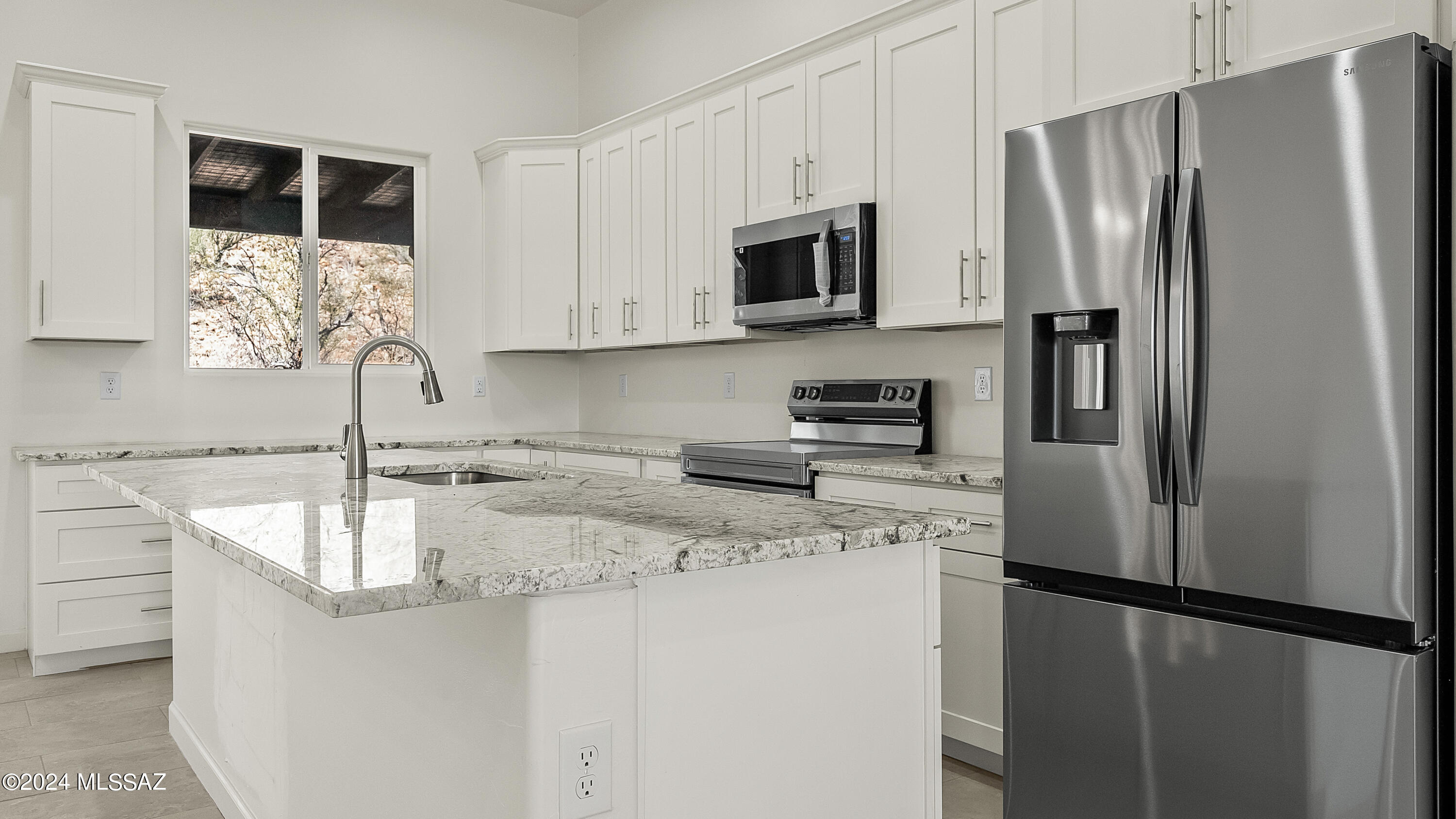 1817 Vereda Iberia Rio Rico, AZ 85648 - Photo 9 of 25 a kitchen with stainless steel appliances granite countertop a refrigerator sink and microwave