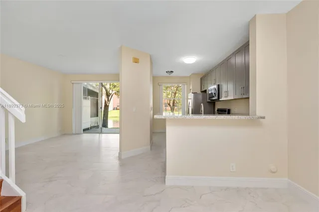a kitchen with stainless steel appliances granite countertop a refrigerator sink and stove