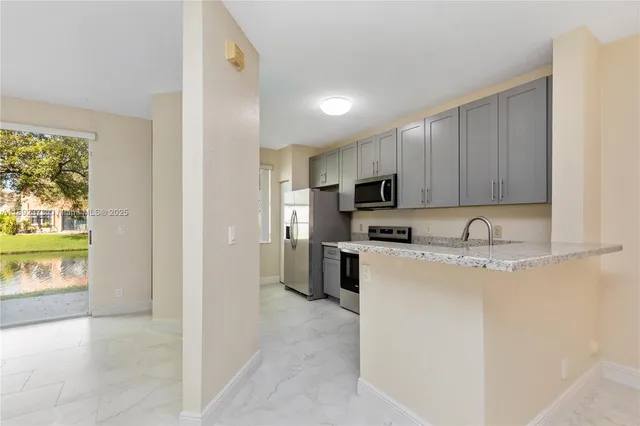 a view of an empty room with a fireplace and a window