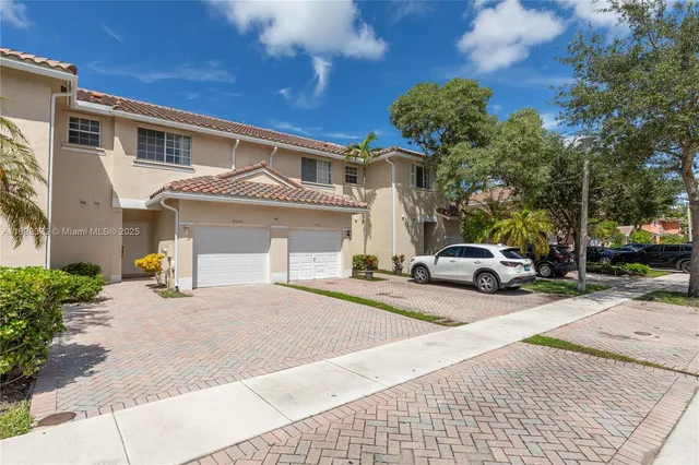 a view of a house with a yard and garage