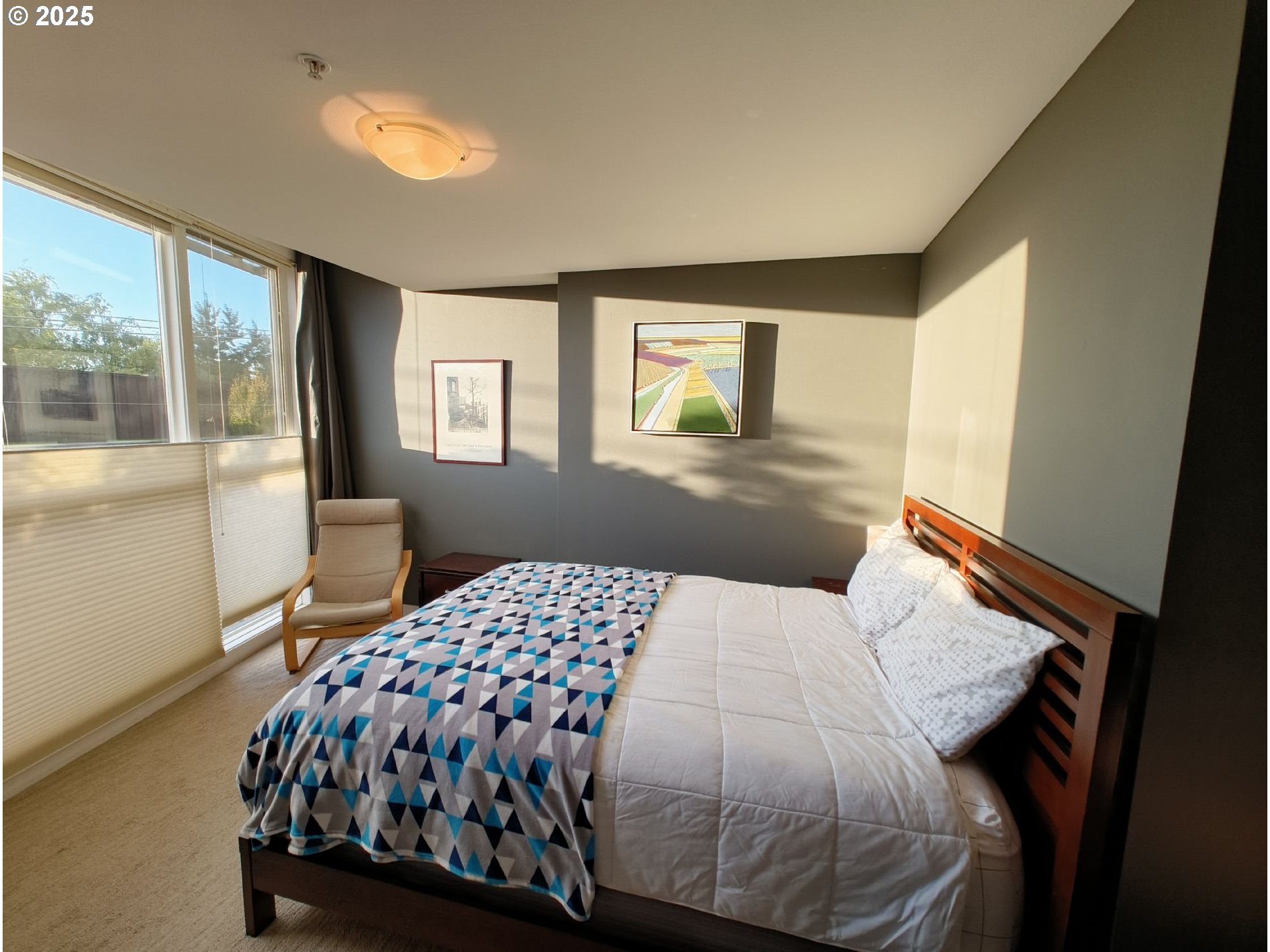 838 Southeast 38th Avenue, Unit 307 Portland, OR 97214 - Photo 12 of 16 a bedroom with a bed and window