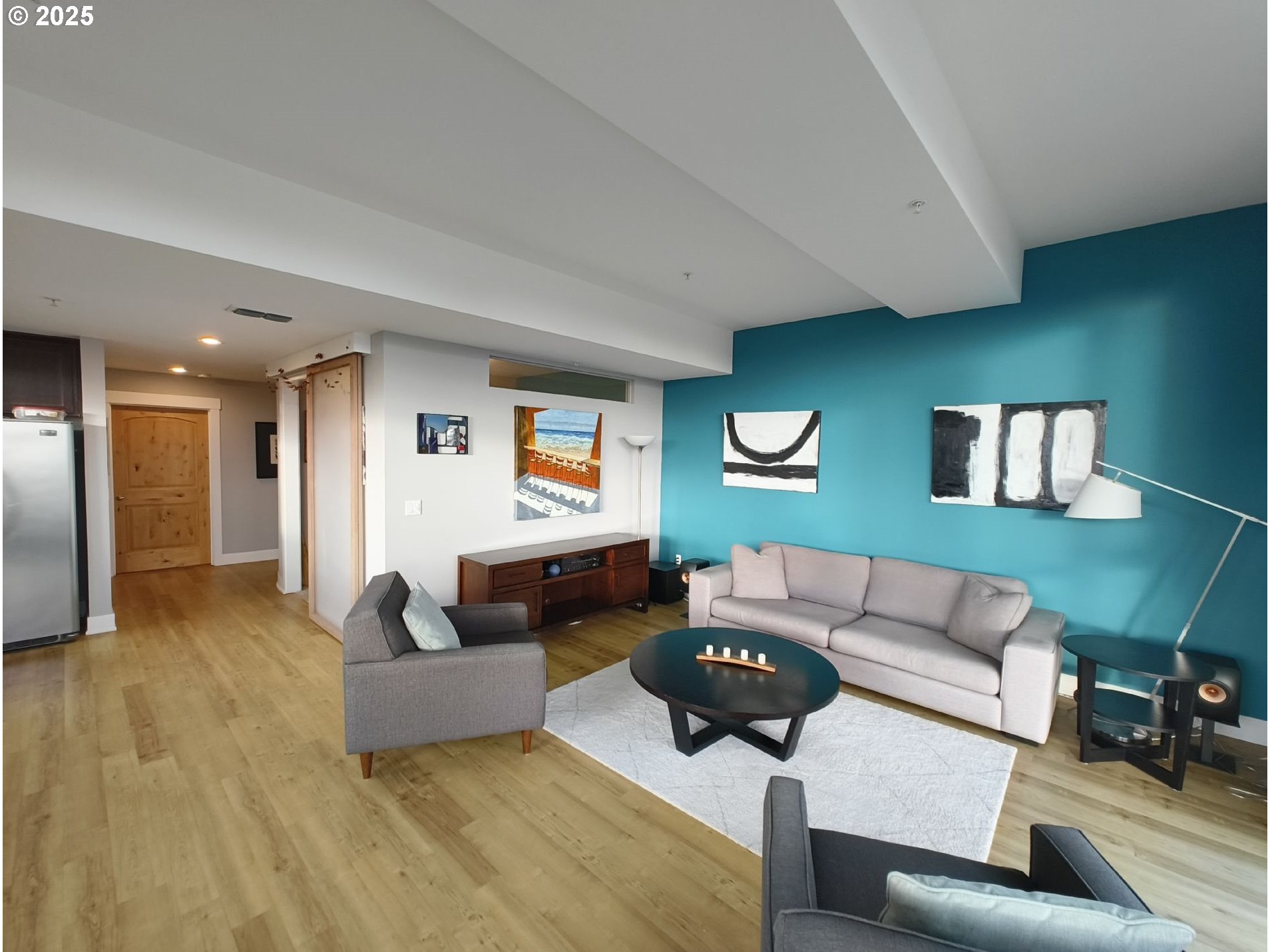 838 Southeast 38th Avenue, Unit 307 Portland, OR 97214 - Photo 7 of 16 a living room with furniture and a wooden floor