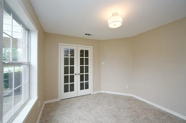 an empty room with windows and entrance