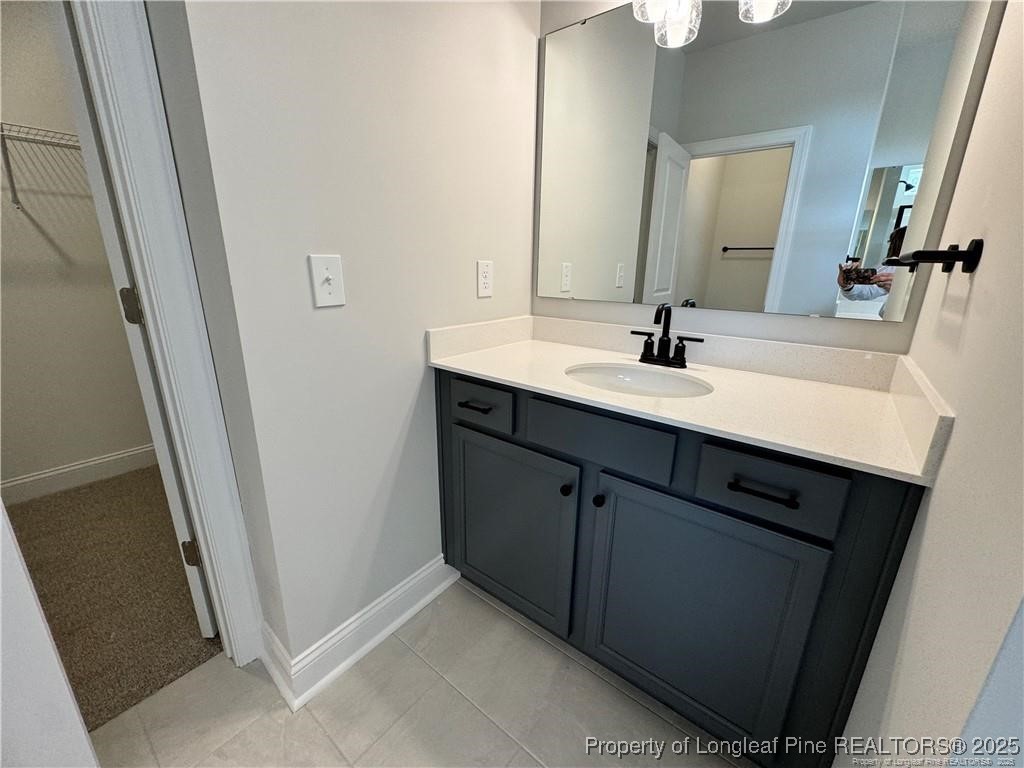 179 Grove Walk Road Raeford, NC 28376 - Photo 11 of 26 a bathroom with a double vanity sink and mirror
