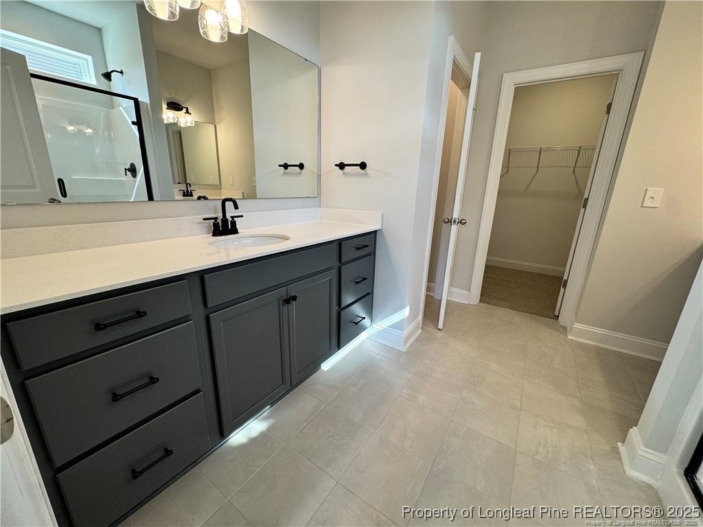 179 Grove Walk Road Raeford, NC 28376 - Photo 13 of 26 a bathroom with a double vanity sink and mirror
