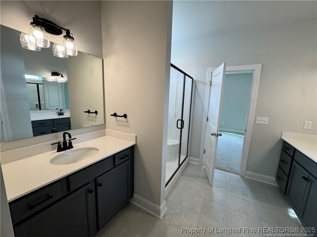 179 Grove Walk Road Raeford, NC 28376 - Photo 16 of 26 a bathroom with a sink double vanity and a mirror