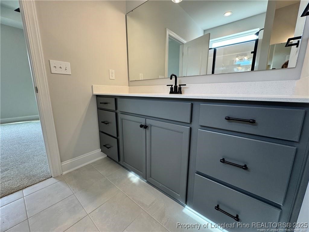 179 Grove Walk Road Raeford, NC 28376 - Photo 18 of 26 a bathroom with a sink and a mirror