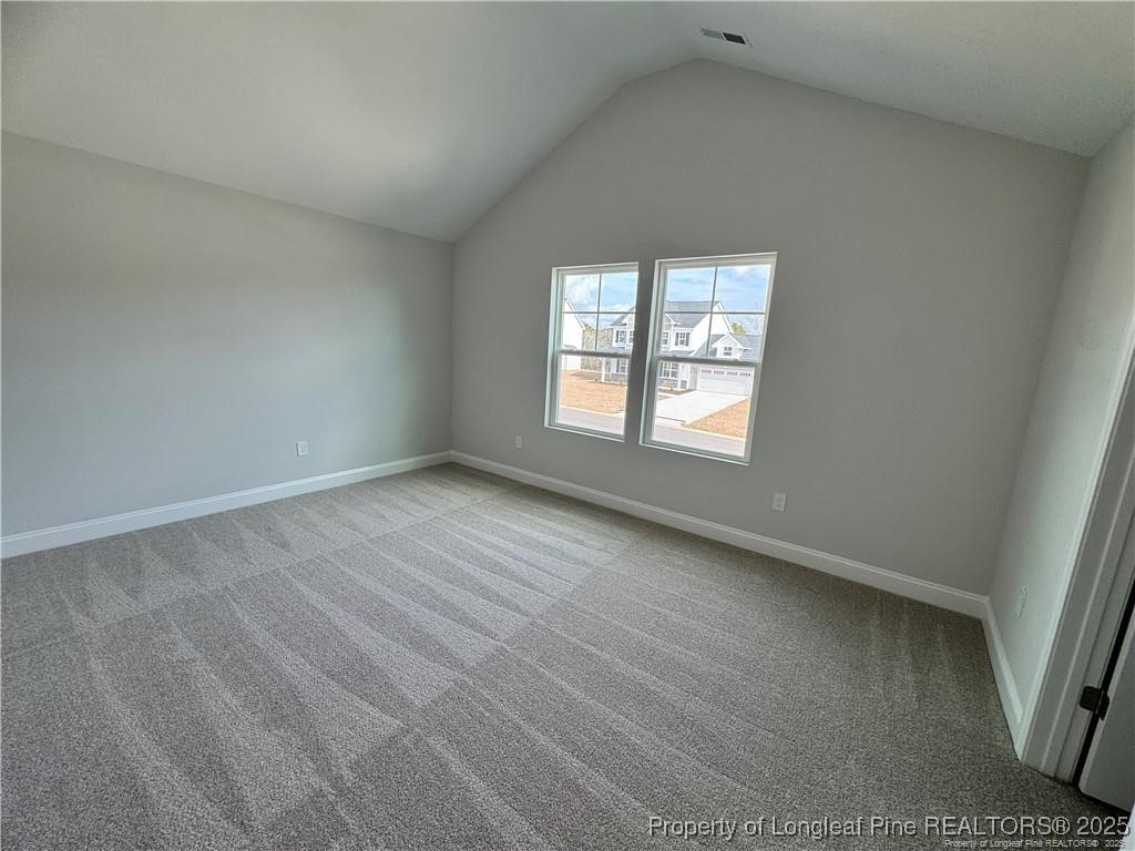 179 Grove Walk Road Raeford, NC 28376 - Photo 23 of 26 an empty room with wooden floor and windows