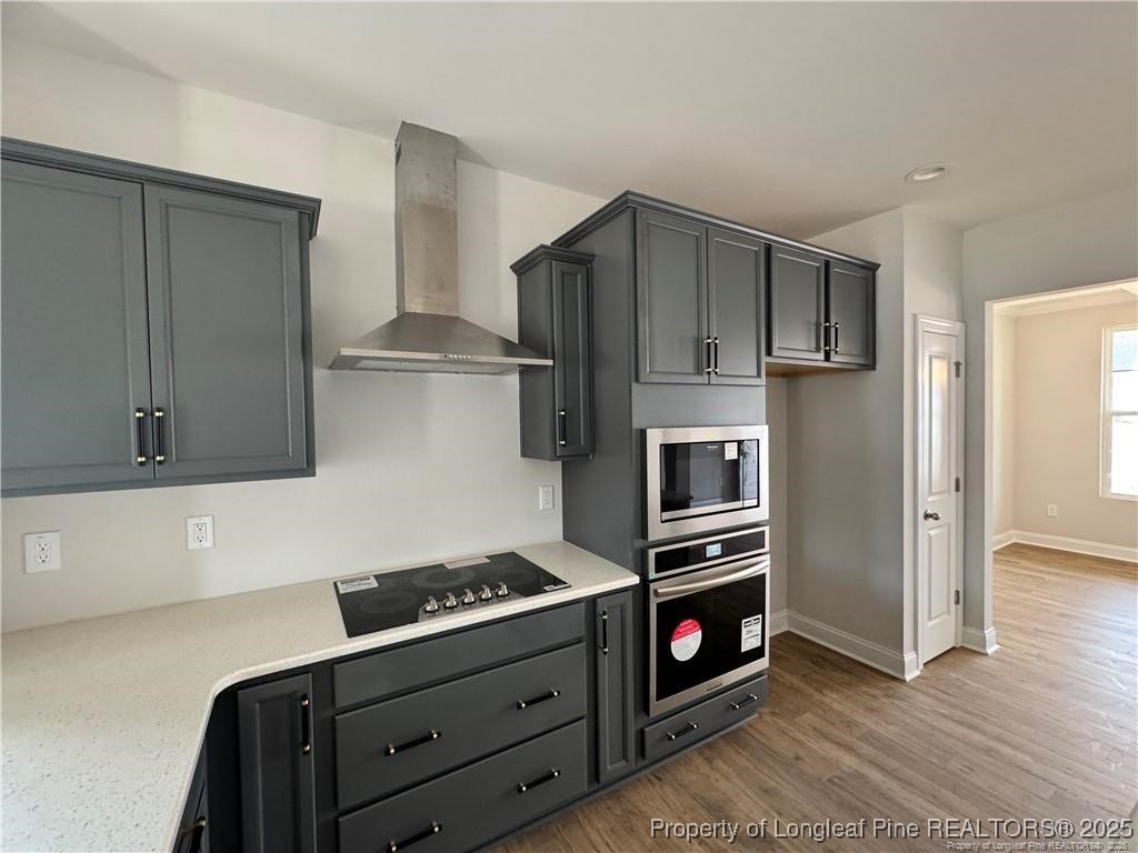 179 Grove Walk Road Raeford, NC 28376 - Photo 25 of 26 a kitchen with stainless steel appliances a stove a microwave and a refrigerator