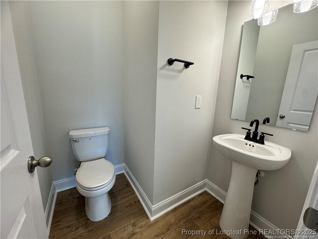 179 Grove Walk Road Raeford, NC 28376 - Photo 26 of 26 a white toilet sitting next to a bathroom sink