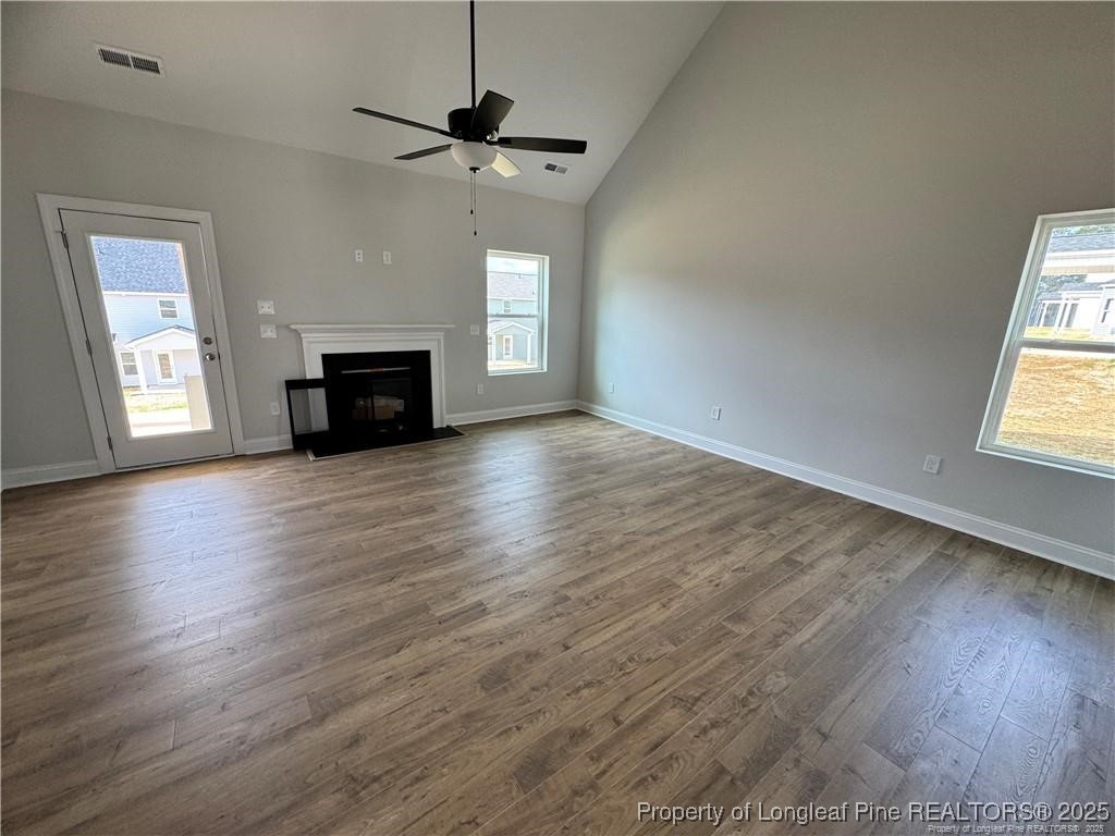 179 Grove Walk Road Raeford, NC 28376 - Photo 6 of 26 an empty room with wooden floor chandelier and windows