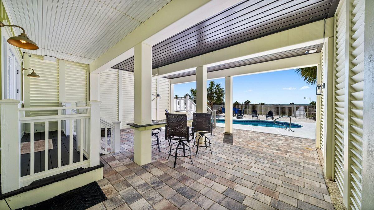 446 Jubilation Drive Port St. Joe, FL 32456 - Photo 37 of 62 a view of a patio with table and chairs and a barbeque