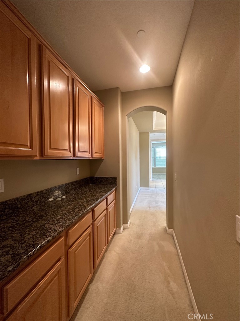 5588 California Oak Street Simi Valley, CA 93063 - Photo 15 of 38 a view of a kitchen with granite countertop cabinets and black stainless steel appliances