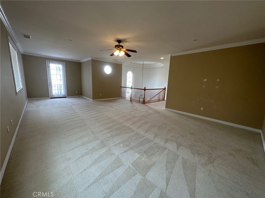 5588 California Oak Street Simi Valley, CA 93063 - Photo 17 of 38 an empty room with chandelier fan and windows