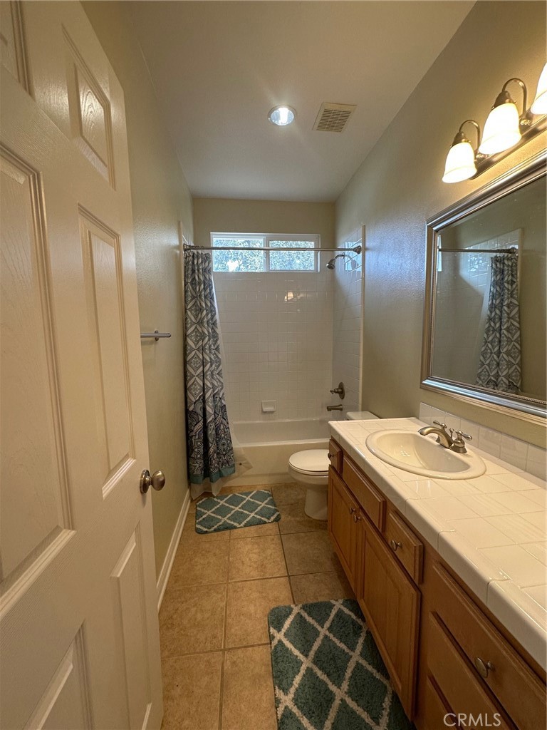5588 California Oak Street Simi Valley, CA 93063 - Photo 22 of 38 a bathroom with a double vanity sink toilet mirror and shower