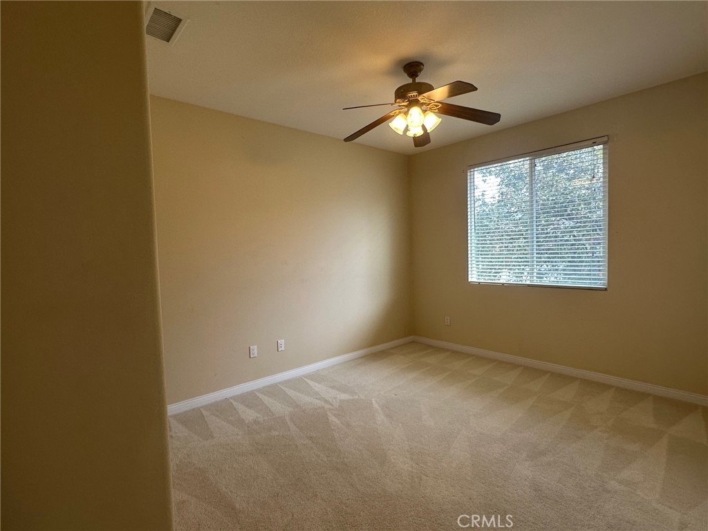 5588 California Oak Street Simi Valley, CA 93063 - Photo 24 of 38 a view of an empty room with a chandelier fan