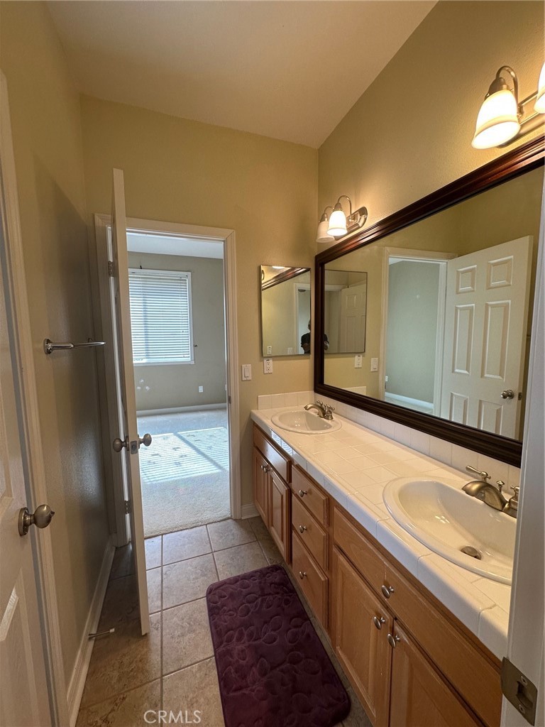 5588 California Oak Street Simi Valley, CA 93063 - Photo 26 of 38 a spacious bathroom with a granite countertop sink mirror and double