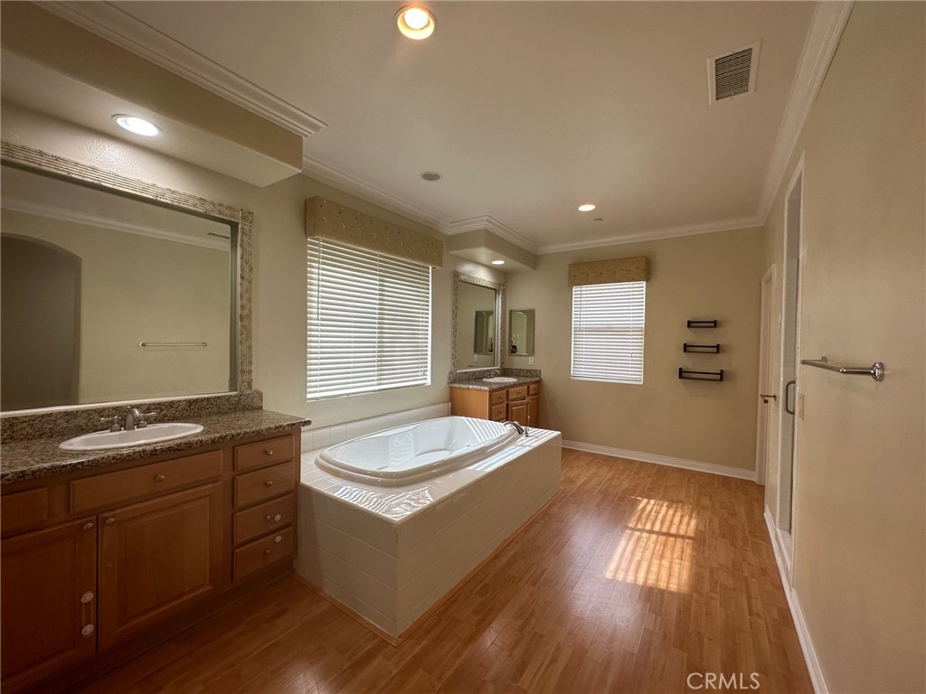 5588 California Oak Street Simi Valley, CA 93063 - Photo 32 of 38 a spacious bathroom with a granite countertop tub sink and mirror