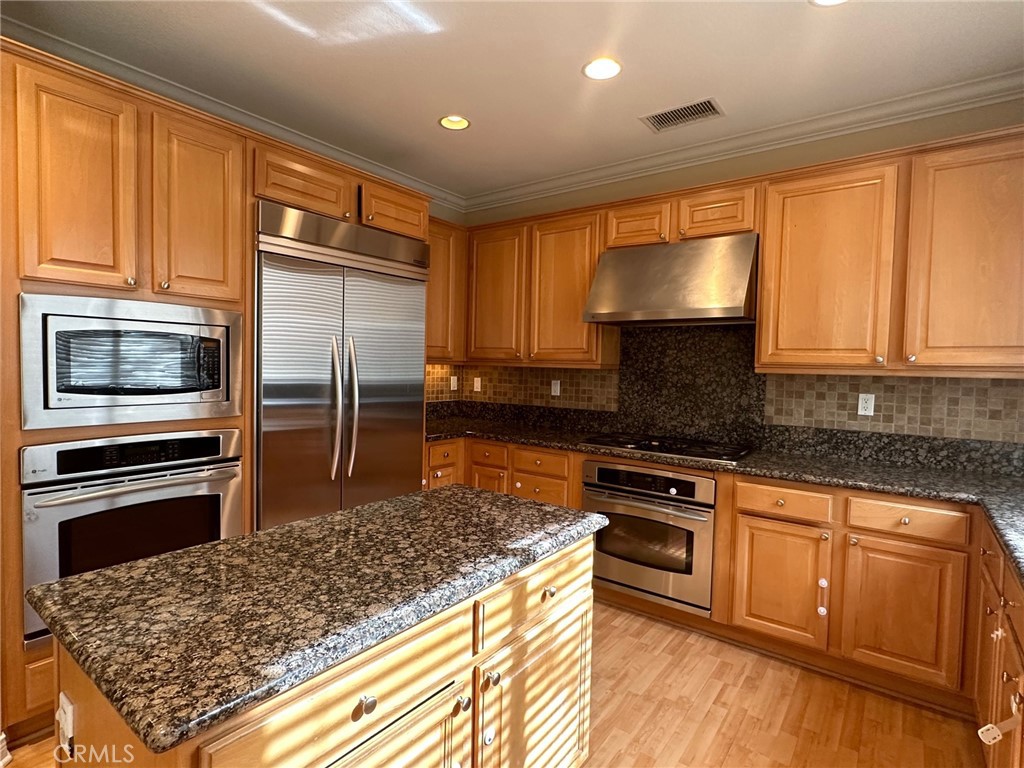 5588 California Oak Street Simi Valley, CA 93063 - Photo 8 of 38 a kitchen with stainless steel appliances granite countertop a stove a sink and a microwave