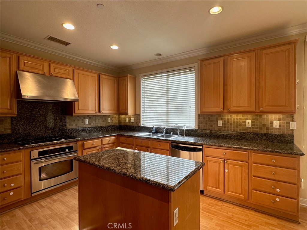 5588 California Oak Street Simi Valley, CA 93063 - Photo 9 of 38 a kitchen with granite countertop a sink a counter space appliances and cabinets
