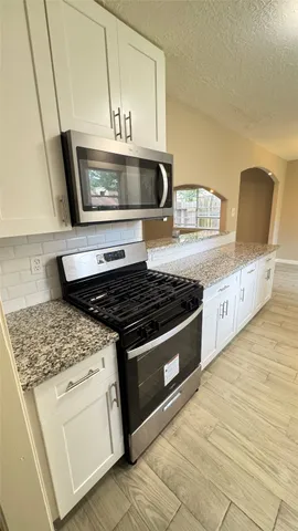 a kitchen with stainless steel appliances granite countertop a stove and a sink