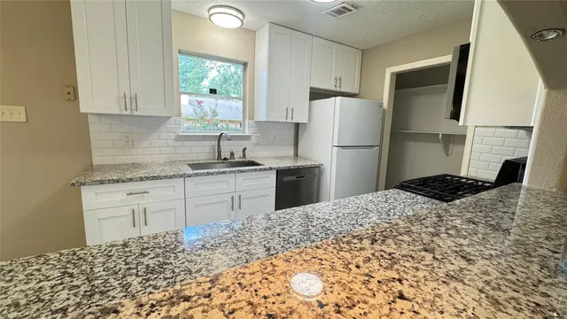 a kitchen with a sink stove and refrigerator