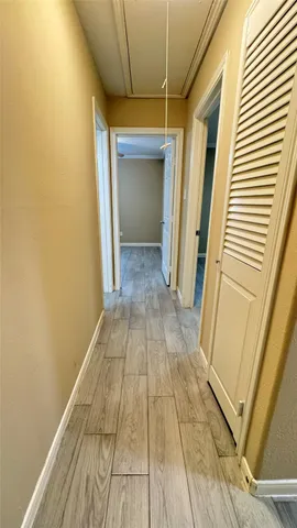 a view of a room with wooden floor and door