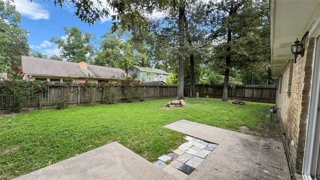 a view of a backyard with a garden and entertaining space
