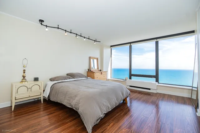 a bedroom with a bed and a large window