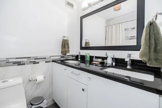 a white toilet sitting next to a bathtub