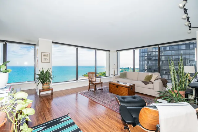 a living room with furniture and floor to ceiling window