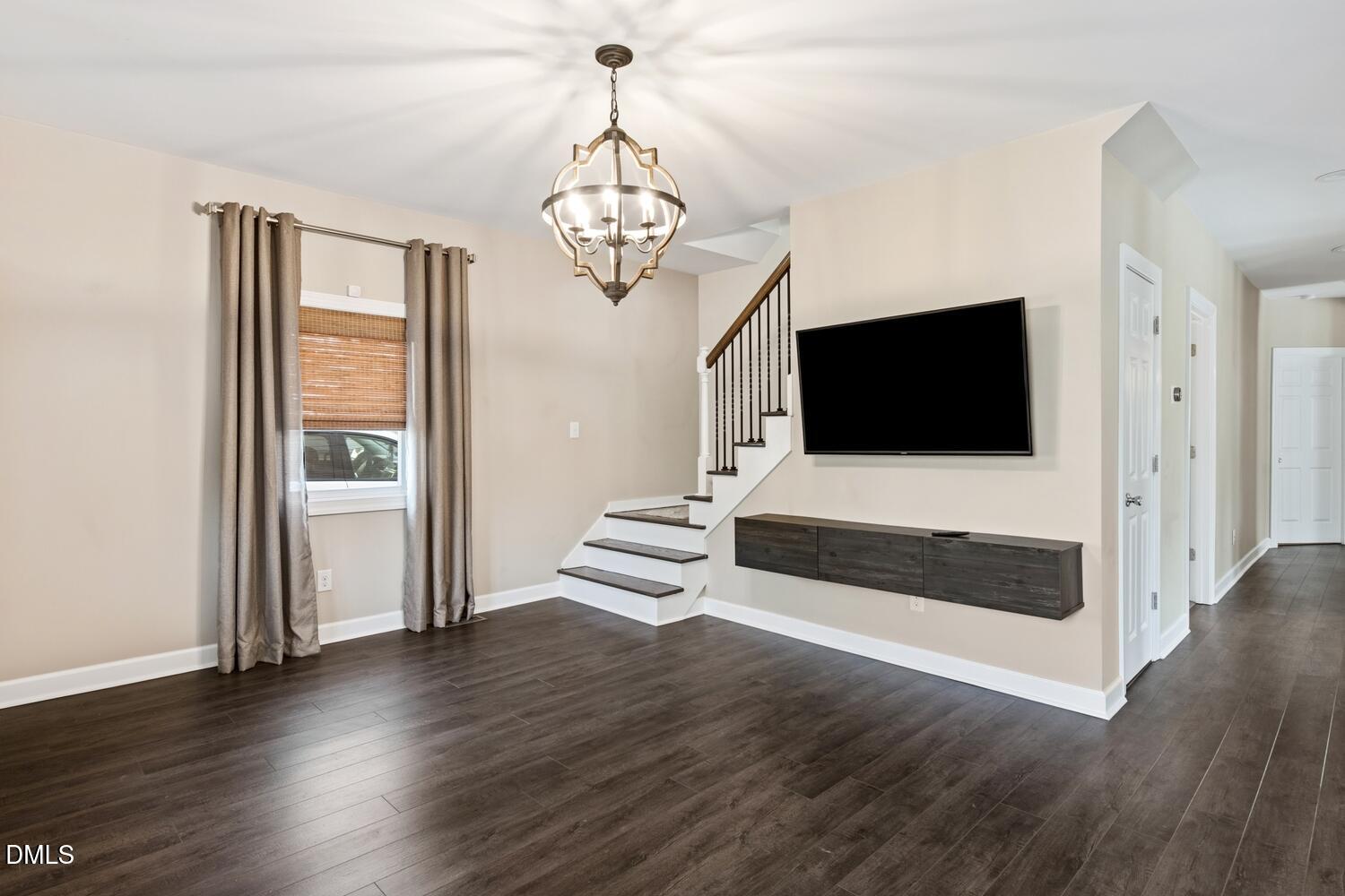 217 Moline Street Durham, NC 27707 - Photo 2 of 30 a living room with wooden floor furniture and a flat screen tv