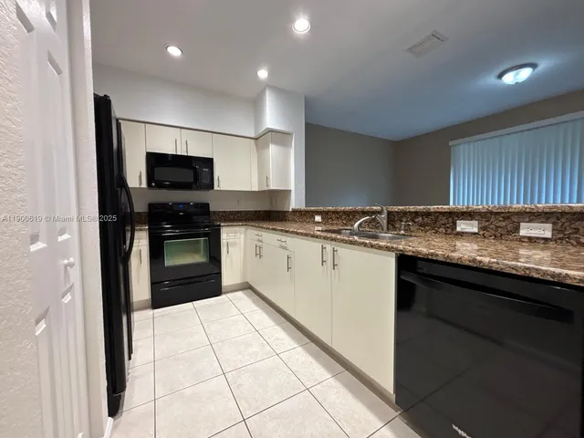 a kitchen with a sink stove and refrigerator