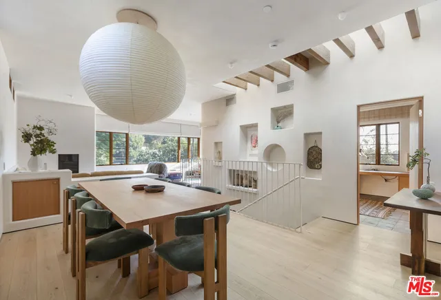 a view of a dining room with furniture and a large window