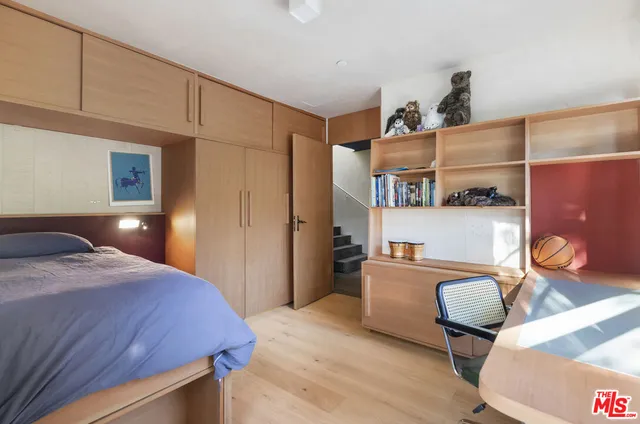 a bed room with a bed and a chair