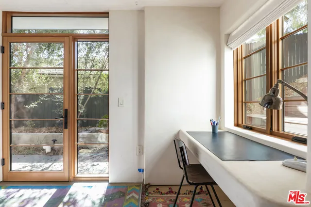 a living room with a couch and a potted plant