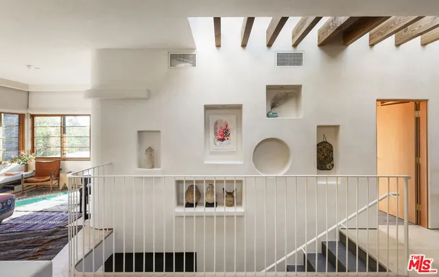 a bedroom with furniture and a large window