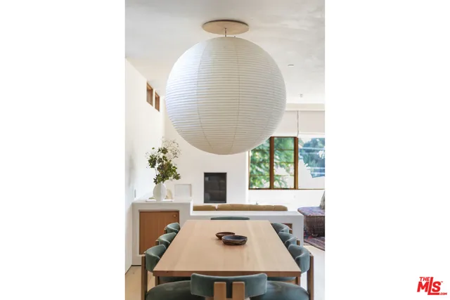 a living room with furniture a rug and a large window