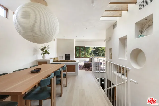 a living room with a large window and a table