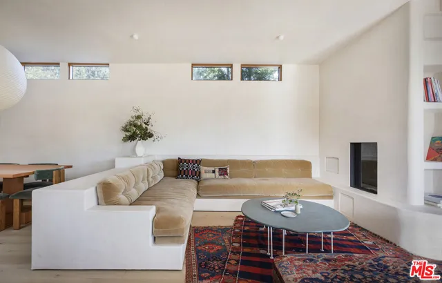 a bedroom with furniture and a book shelf