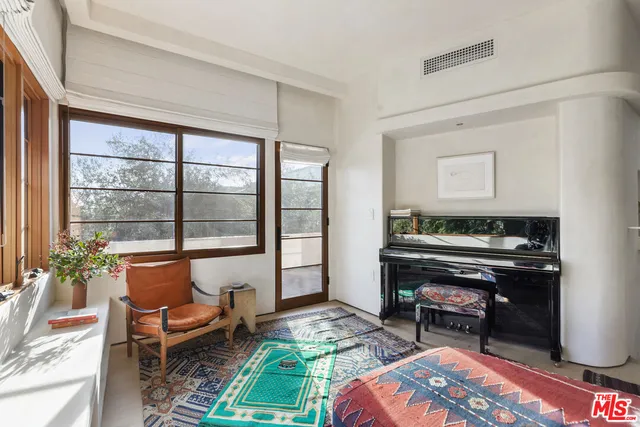 a bedroom with furniture and a window