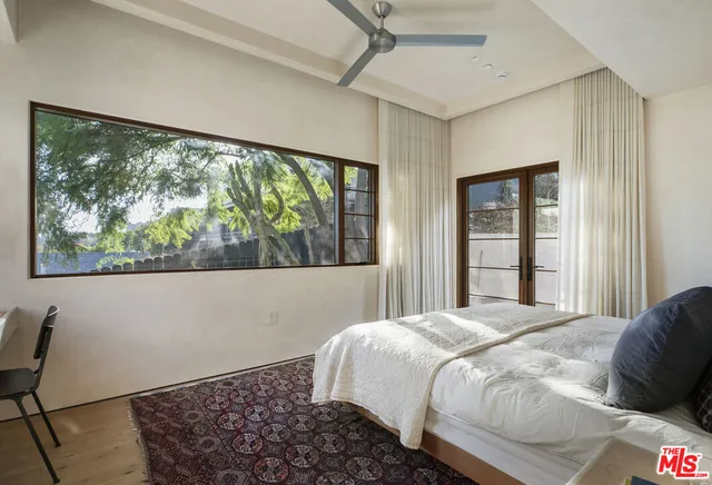 a kitchen with stainless steel appliances a stove a sink dishwasher and white cabinets with wooden floor