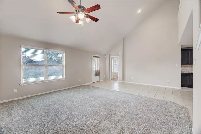 a view of a livingroom with a ceiling fan and window