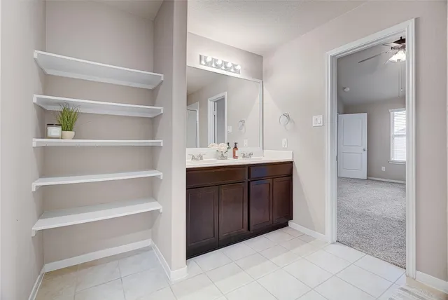 a bathroom with a sink vanity and mirror