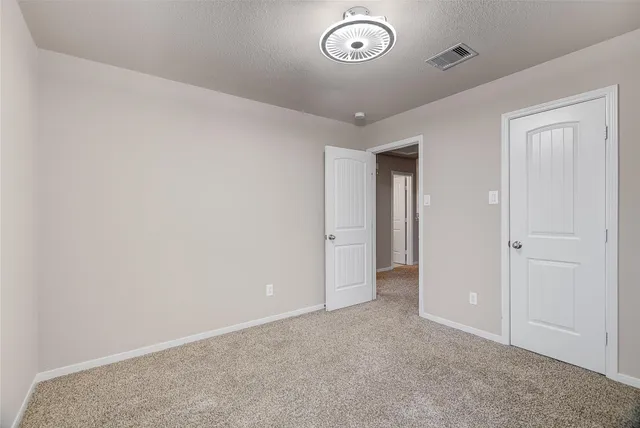 an empty room with a empty space and windows